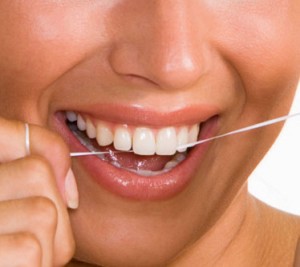 Photo of woman flossing her teeth at her Abbotsford Dental clinic