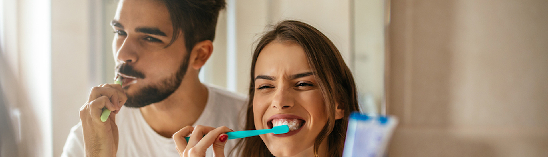 Shot of a happy couple bonding while brushing teeth in the bathroom. Preventive care and oral hygiene